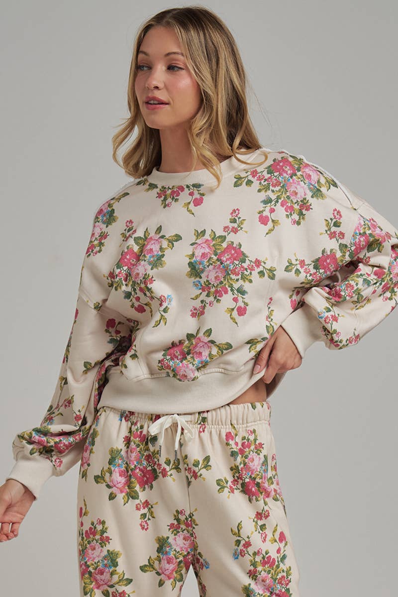 Woman wearing a floral pajama set against a gray background